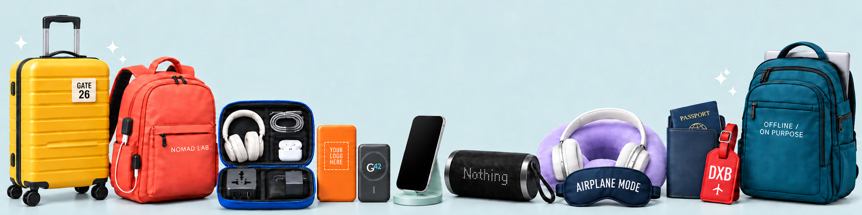 Custom Travel and Tech merchandise featuring a cabin suitcase, branded travel backpacks, an open tech organiser, two power banks, wireless phone charger, premium speakers, headphones, neck pillow, passport wallet and luggage tag